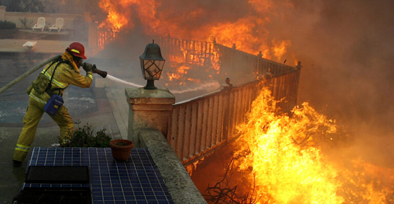 A firefighter battles flames during the September 2012 Shockey wildland fire near San Diego.