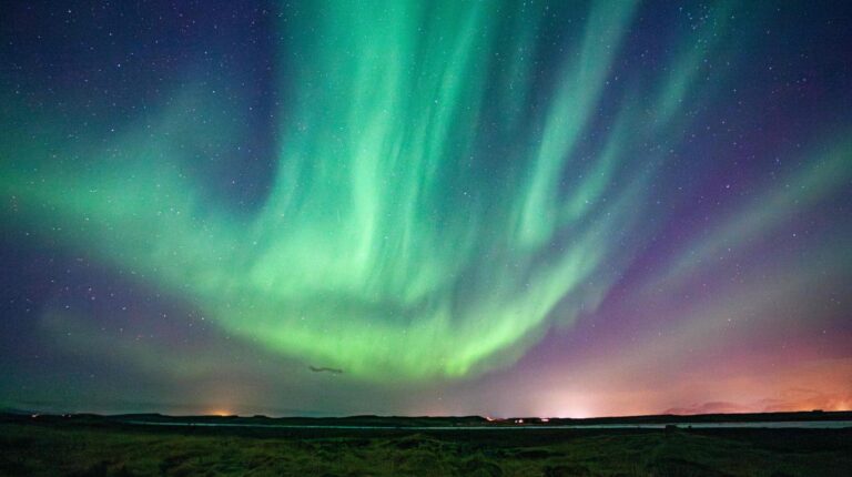 A green sky of shimmering and dancing Northern Lights, aurora, in Iceland