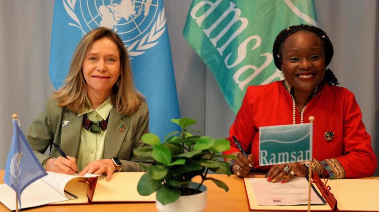 Celeste Saulo, secretary-general of the World Meteorological Organization (WMO) and Dr Musonda Mumba, secretary-general of the Convention on Wetlands (RAMSAR) sit at a table to sign a cooperation agreement. Image: WMO