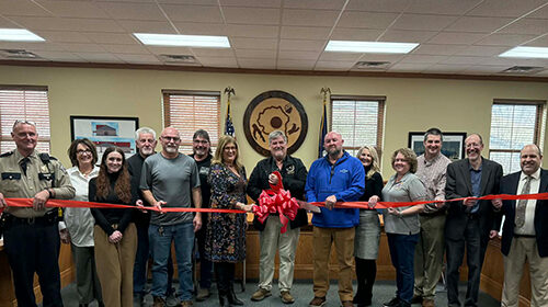 Representatives of various meteorological and governmental organizations attend a ribbon cutting ceremony.